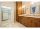 Bathroom featuring double vanity, beautiful tile floors, and walk-in closet access at 1002 Periwinkle Ct, Celebration, FL 34747