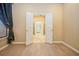 Bright bedroom featuring wood floors and an open doorway to the walk-in closet at 1002 Periwinkle Ct, Celebration, FL 34747