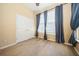 Bedroom showcasing a double door closet, light-colored wood flooring and three bright windows at 1002 Periwinkle Ct, Celebration, FL 34747