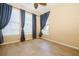 Bright bedroom with three windows dressed in stylish blue curtains and neutral paint at 1002 Periwinkle Ct, Celebration, FL 34747