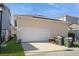 Exterior view of a detached garage with solar panels and a white door at 1002 Periwinkle Ct, Celebration, FL 34747