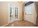 Living room featuring doors to the exterior and a double door entryway; light hard wood flooring at 1002 Periwinkle Ct, Celebration, FL 34747