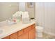 Bathroom with double vanity, toilet and shower features decoratively folded towels at 1802 Royal Ridge Dr, Davenport, FL 33896