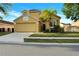 Charming yellow two-story home with a well-manicured lawn and attached two-car garage at 1802 Royal Ridge Dr, Davenport, FL 33896