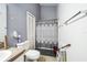 Cozy bathroom featuring a standard toilet, vanity, and shower/tub with grey accents at 319 Bailey Cir, Davenport, FL 33897