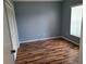 Simple bedroom with wood floors, a window with blinds, and a closet with sliding doors at 319 Bailey Cir, Davenport, FL 33897