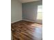Clean bedroom with wood flooring and a window bringing in natural light at 319 Bailey Cir, Davenport, FL 33897