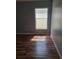 Bright room showcasing wood flooring with natural light streaming through the window at 319 Bailey Cir, Davenport, FL 33897