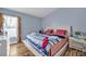Inviting bedroom with a comfortable bed, large window, and stylish wood laminate flooring at 319 Bailey Cir, Davenport, FL 33897