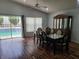 Elegant dining area with modern table set, views of pool area, and wood laminate flooring at 319 Bailey Cir, Davenport, FL 33897