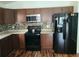 Well-equipped kitchen with modern appliances, a stylish backsplash, and wood-look flooring at 319 Bailey Cir, Davenport, FL 33897