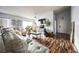 Bright living room featuring a large sofa, wood flooring, modern lighting, and a stylish decor at 319 Bailey Cir, Davenport, FL 33897