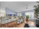 Bright living room with large windows, stylish decor, and a full wall fish tank feature at 319 Bailey Cir, Davenport, FL 33897