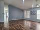 Spacious living room featuring wood flooring and natural light from adjacent windows at 319 Bailey Cir, Davenport, FL 33897