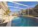 Inviting screened-in pool area with well-maintained pool and lush landscaping at 319 Bailey Cir, Davenport, FL 33897