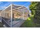 Screened in outdoor pool with deck and view of back yard of single Gathering home at 319 Bailey Cir, Davenport, FL 33897