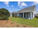 Exterior view of backyard with covered patio and green lawn at 5932 Bristle Oak St, Mount Dora, FL 32757