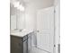 Well-lit bathroom with a gray vanity, white countertop, and modern light fixture at 5932 Bristle Oak St, Mount Dora, FL 32757