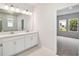 Bathroom featuring double sink vanity with white cabinets, quartz countertops and tile flooring at 5932 Bristle Oak St, Mount Dora, FL 32757