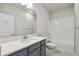 Bathroom featuring a vanity with gray cabinets, a tub with white tile, and light gray walls at 5932 Bristle Oak St, Mount Dora, FL 32757