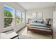 Bright bedroom featuring three windows that let in a lot of light, complemented by neutral walls at 5932 Bristle Oak St, Mount Dora, FL 32757