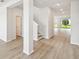 Bright foyer with elegant wood-look floors, neutral paint, and an open floor plan leading to the living areas at 5932 Bristle Oak St, Mount Dora, FL 32757