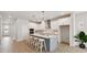 Bright, modern kitchen with white cabinets, stainless steel appliances, and large island with counter seating at 5932 Bristle Oak St, Mount Dora, FL 32757