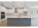 Stylish kitchen with an island, white cabinetry, stainless steel appliances, and pendant lighting at 5932 Bristle Oak St, Mount Dora, FL 32757