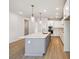 Kitchen with a spacious island, pendant lighting, and white cabinetry at 5932 Bristle Oak St, Mount Dora, FL 32757
