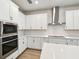 Close up view of the kitchen with stainless steel appliances and white cabinetry at 5932 Bristle Oak St, Mount Dora, FL 32757