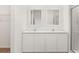 Bathroom featuring a double vanity with quartz countertops, white cabinets, and a glass enclosed shower at 1633 Nantucket Way, Winter Haven, FL 33884