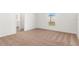Bright bedroom with neutral carpet, white walls, and a window offering natural light at 1782 White Elephant Loop, Winter Haven, FL 33884