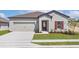 Charming single-story home showcasing a two-car garage, neat lawn, and eye-catching red door and window shutters at 1782 White Elephant Loop, Winter Haven, FL 33884