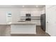 Stylish kitchen boasting white cabinetry, stainless steel appliances, granite countertops, and a convenient center island at 1782 White Elephant Loop, Winter Haven, FL 33884