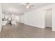 Open-concept living area connecting seamlessly to the kitchen, highlighted by stylish wood floors and ample natural light at 1782 White Elephant Loop, Winter Haven, FL 33884