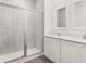 Bathroom featuring a tiled shower with glass door and double sink vanity at 1791 White Elephant Loop, Winter Haven, FL 33884