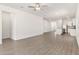 Open-concept living room flows into kitchen, featuring wood-look flooring and bright natural light at 1791 White Elephant Loop, Winter Haven, FL 33884