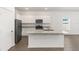 Modern kitchen with white cabinets, granite countertops, a center island, and stainless steel appliances at 1802 White Elephant Loop, Winter Haven, FL 33884