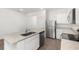 Well-lit kitchen with white cabinets, granite countertops, stainless steel appliances, and an island with a sink at 1802 White Elephant Loop, Winter Haven, FL 33884