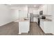Spacious kitchen featuring white cabinets, granite countertops, stainless steel appliances, and a functional island at 1802 White Elephant Loop, Winter Haven, FL 33884
