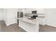 Beautiful kitchen with white cabinetry, granite countertops, an island with a sink, and stainless steel appliances at 1802 White Elephant Loop, Winter Haven, FL 33884