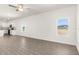 Spacious living room with hardwood floors, large windows, and an open layout to the kitchen at 1802 White Elephant Loop, Winter Haven, FL 33884