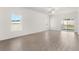 Bright, open living room with hard floors, a ceiling fan, natural light, and backyard access at 1802 White Elephant Loop, Winter Haven, FL 33884