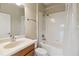 Compact bathroom with a single sink vanity, toilet, and a shower-tub combination with a white shower curtain at 1892 Sanderling Dr, Clermont, FL 34711