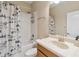 Bathroom with shower-tub combination, mountain shower curtain and a single sink vanity at 1892 Sanderling Dr, Clermont, FL 34711