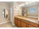 Bathroom featuring double sinks, granite countertops, separate tub, and walk-in shower at 1892 Sanderling Dr, Clermont, FL 34711