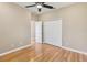 This bedroom features laminate floors, a ceiling fan, and a double closet at 1892 Sanderling Dr, Clermont, FL 34711