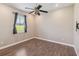 Bedroom with hardwood floors, ceiling fan, and a large window at 1892 Sanderling Dr, Clermont, FL 34711