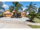Charming single-Gathering home featuring a three-car garage, well-maintained landscaping, and lovely palm trees at 1892 Sanderling Dr, Clermont, FL 34711