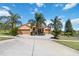 Beautiful home with a wide driveway and well-manicured landscaping including mature palms at 1892 Sanderling Dr, Clermont, FL 34711